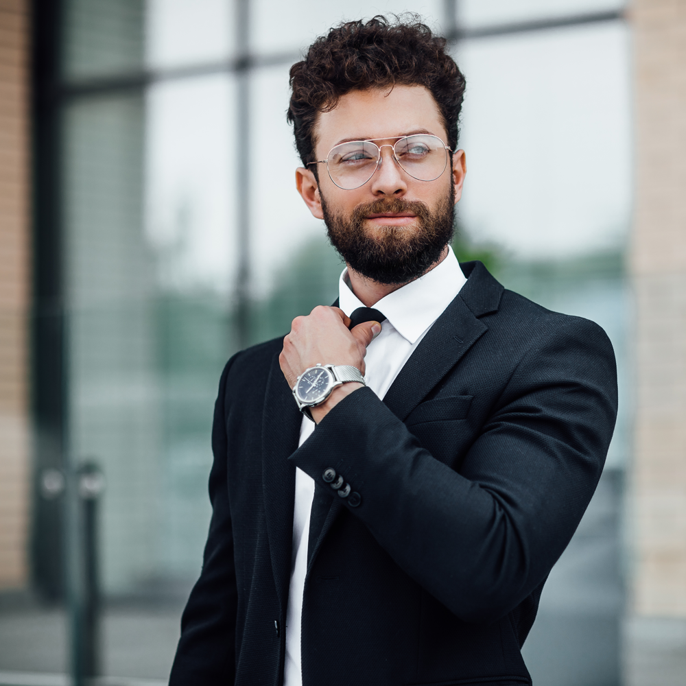 portrait-handsome-man-black-business-suit-with-watch-his-hand