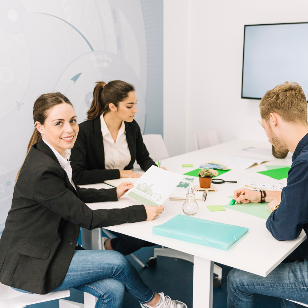 portrait-smiling-young-businesswoman-near-her-colleagues-working-office portrait-smiling-young-businesswoman-near-her-colleagues-working-office
