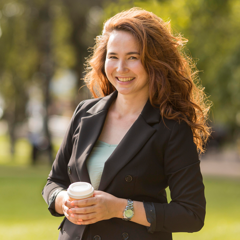 smiley-woman-with-curly-hair-posing-with-copy-space